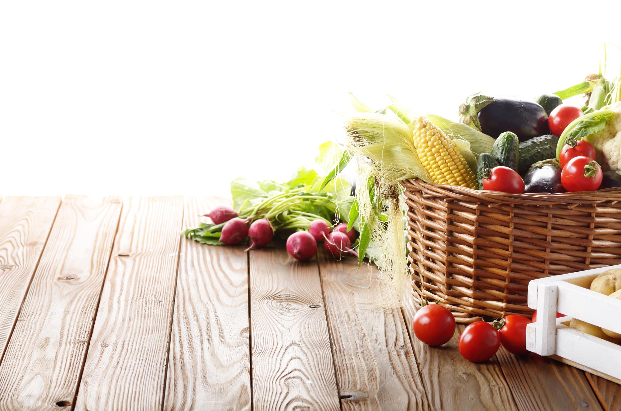 Selection of fresh seasonal vegetables on wooden table